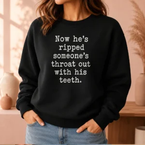Top Now He'S Ripped Someone'S Throat Out With His Teeth sweater in black, front view with bold graphic text